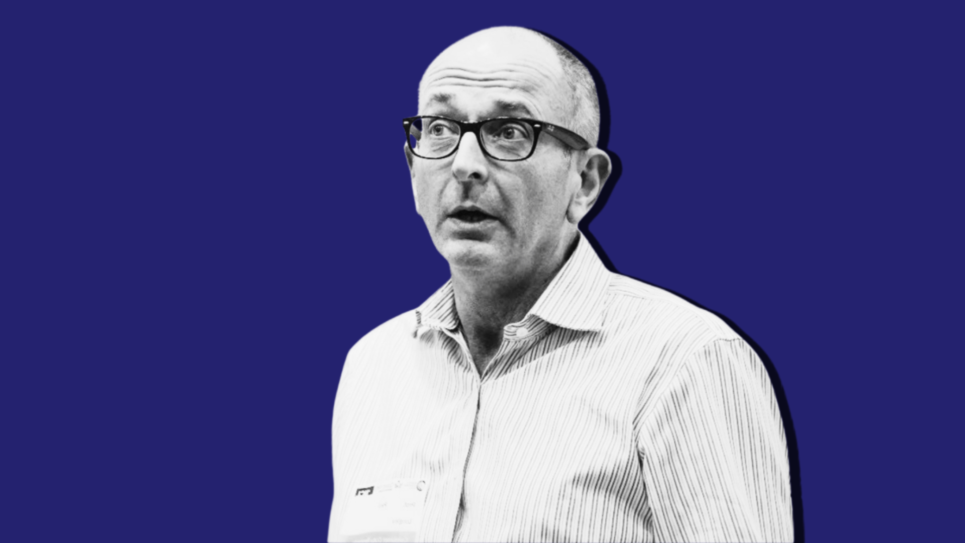 Professor Paul Longley's black and white portrait is overlayed onto a dark blue background